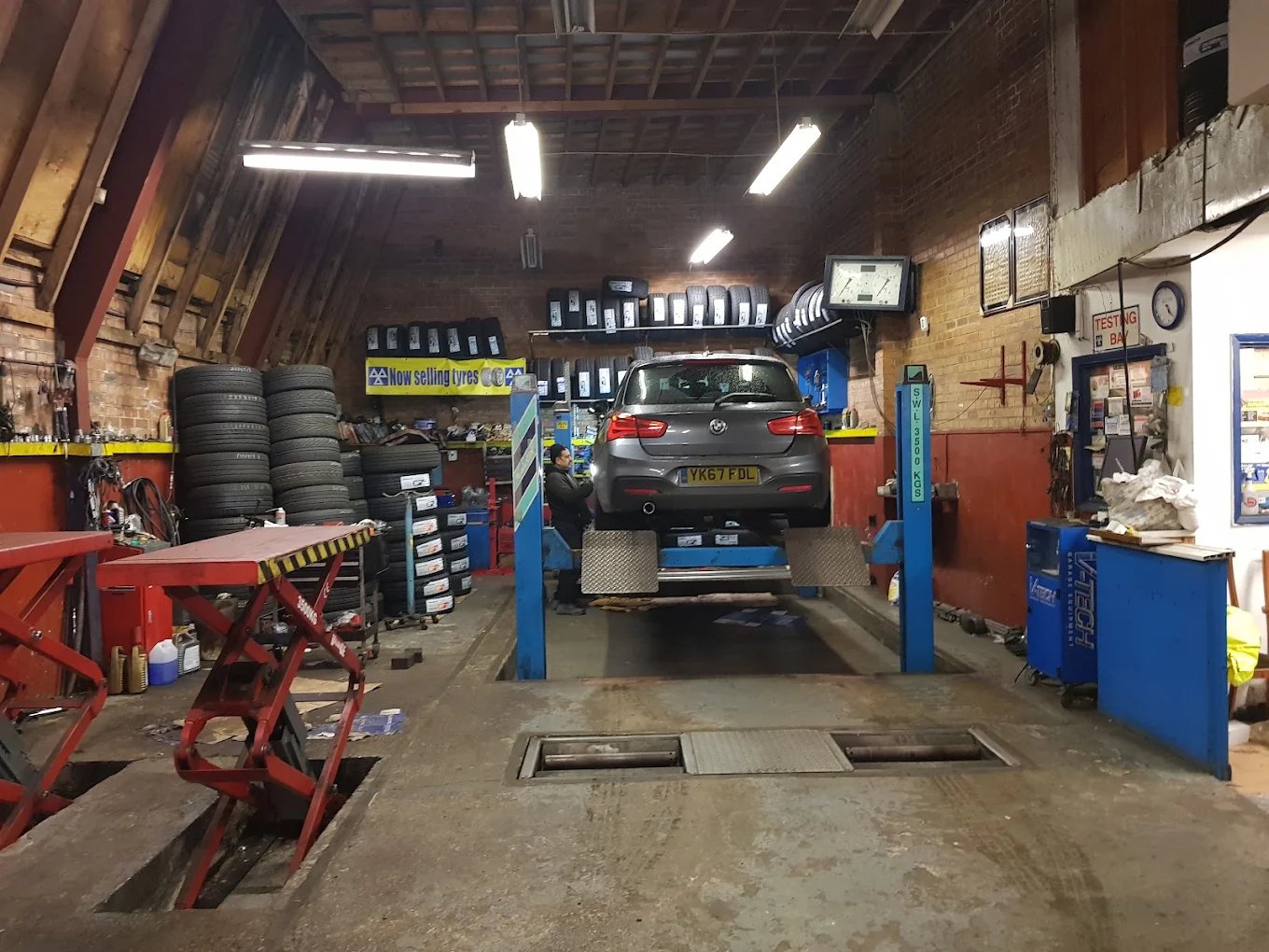 Interior workshop with car on ramp at Derby Service Centre
